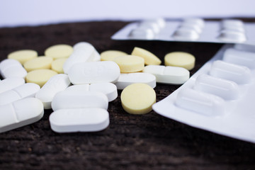 pill bottle spilling pills on the wooden floor