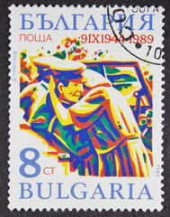 A stamp printed in Bulgaria, shows Couple embracing in September 9 Revolution, 45th Anniv. series, 1989