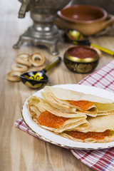 Pancakes with red caviar on a table