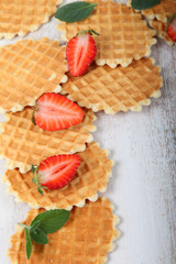 Waffles, mint and ripe strawberries.