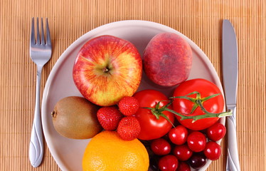Fresh fruits and vegetables on plate, healthy nutrition