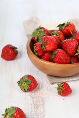 Ripe strawberries in a brown bowl