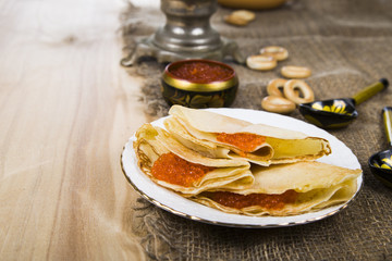 Pancakes with caviar on the table with a samovar