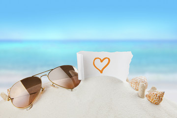Fototapeta na wymiar heart, love symbol paper on beach,holiday concept