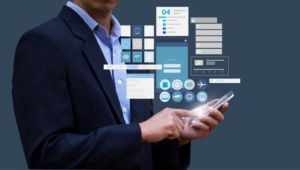Businessman pressing on smartphone and applications tools. Design concept of Business and technology. Smartphone Technology