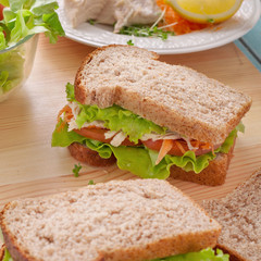 Sandwich with chicken on a wooden board