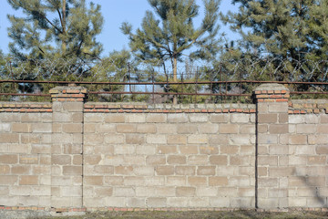 The prison walls with barbed wire