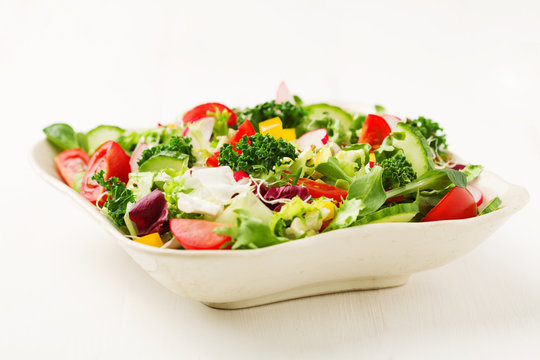 Spring salad with fresh vegetables from radishes and kale
