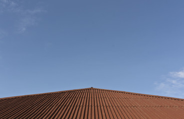 Modern brown roof and blue sky.