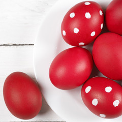 Red Easter eggs in plate