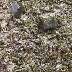 green epidote crystals on rock close up