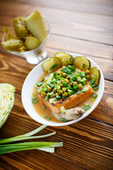 Puree soup with green peas, pickled cucumbers and croutons