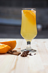 Lemonade with orange and spices on the table