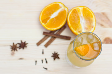 Lemonade with orange and spices on the table