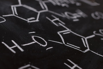Fototapeta na wymiar Chemical formula on blackboard - handwritten