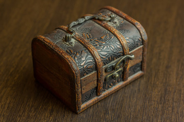 closed treasure chest on wooden table
