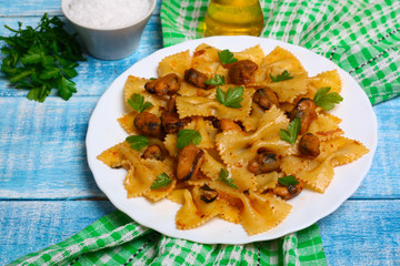 pasta with mussels and parsley on a wooden background
