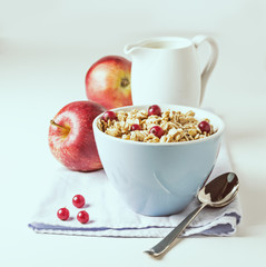 Breakfast with granola and fresh berries on white with free text space. Selective focus.