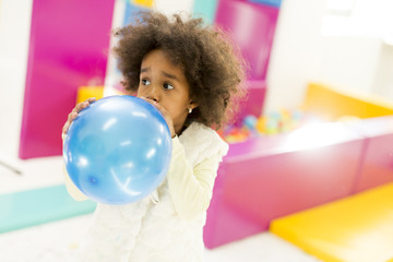 Black little girl with a balloon