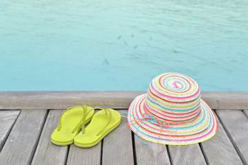 Colorful hat and sandal on the deck by the sea, Maldives