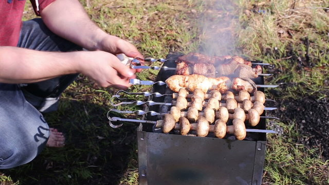 Man cooking kebabs on the grill brazier