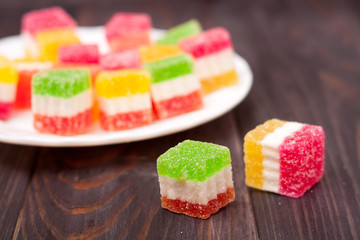 Jelly sweet, flavor fruit, candy dessert colorful on wood background.