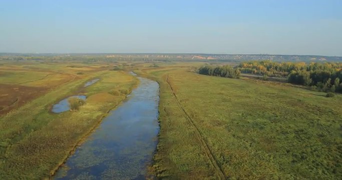 Panoramic Autumn landscape. The picturesque landscape with river, trees and field.