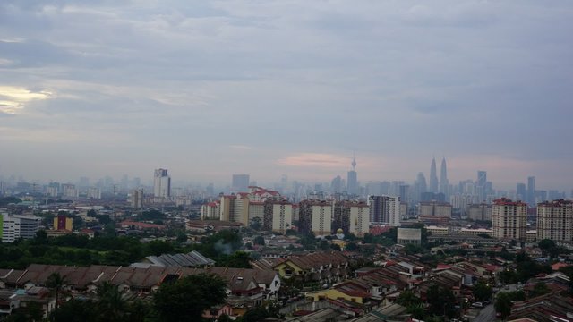 Time lapse view of downtown Kuala Lumpur, Malaysia with Petronas Twin Towers as the highest peak in the middle of it.
