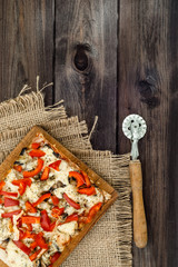 Piece of pizza on wooden background.
