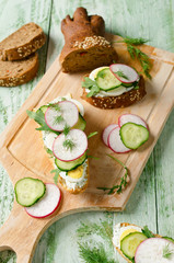 Sandwiches with egg, radish, cucumber and arugula