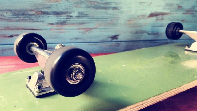 cinemagraph of a skateboard face down with its wheels spinning