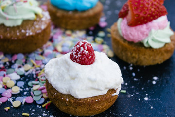 Obraz na płótnie Canvas Cupcake with white cream and raspberry