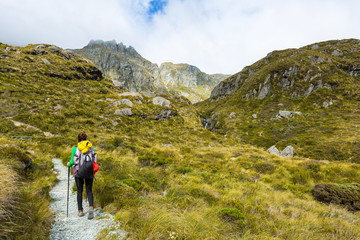 woman hiker with backpack hiking on Routeburn Track