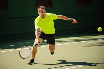 Man plays tennis in bright cloth