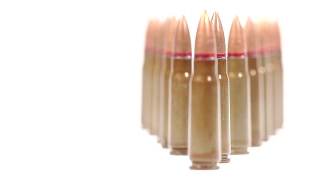 AK 47 ammunition. Defocus on a diagonal bunch of upright bullets.
From the foremost to the rearmost. 