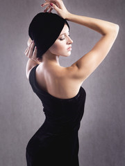 Fototapeta premium girl posing on a gray background in a dress