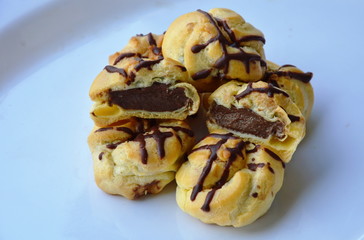 eclair filling chocolate cream on white plate