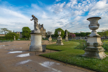 Fototapeta na wymiar Classical statues adorn the public parks and gardens of Paris, France