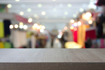 Top of wood table on  blurred  in department stores. you can be used for display your products