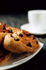 Homemade bakery with chocolate on dark wooden table.