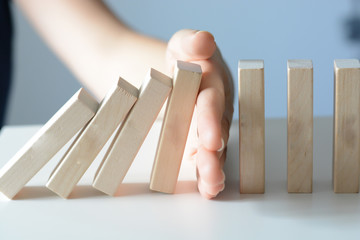 Stopping the domino effect concept with a business solution and intervention - 102504394
