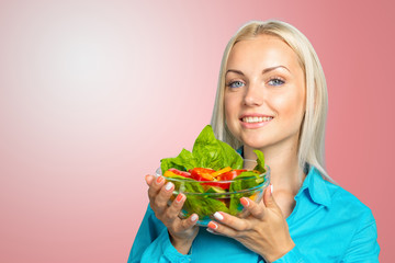 Beautiful girl eating fresh vegetable salad