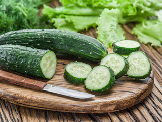 Cucumbers on the wooden table.