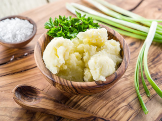 Mashed potatoes in the wooden bowl on the service tray.