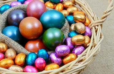 Colorful egg and chocolate for Easter in basket
