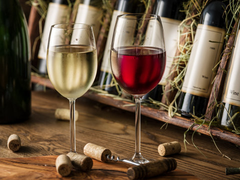 Wine bottles on the wooden shelf.