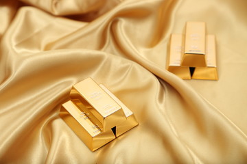 Gold bullion  isolated on gold cloth