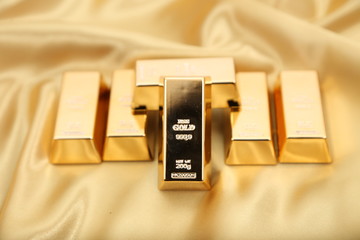 Gold bullion  isolated on gold cloth