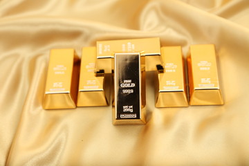 Gold bullion  isolated on gold cloth