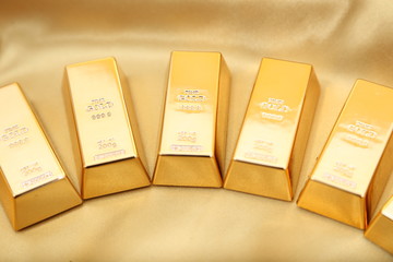 Gold bullion  isolated on gold cloth